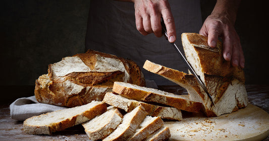 man-cutting-bread-with-sharp-kitchen-knife