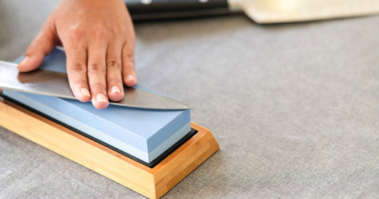 man-sharpening-knife-on-stone