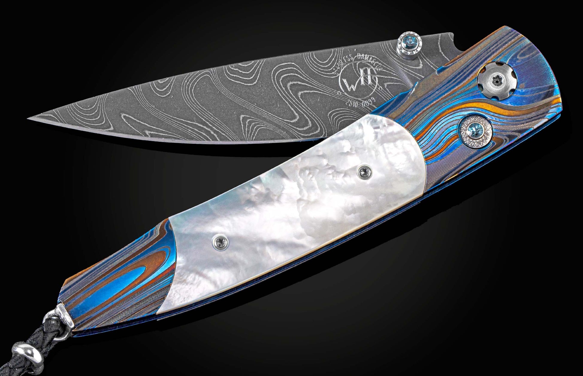 Exclusive edition knife from William Henry with a 'Laser Blue' finished frame in aerospace grade titanium, mother of pearl scales, London Blue topaz and a hand-forged damascus steel blade by Chad Nichols