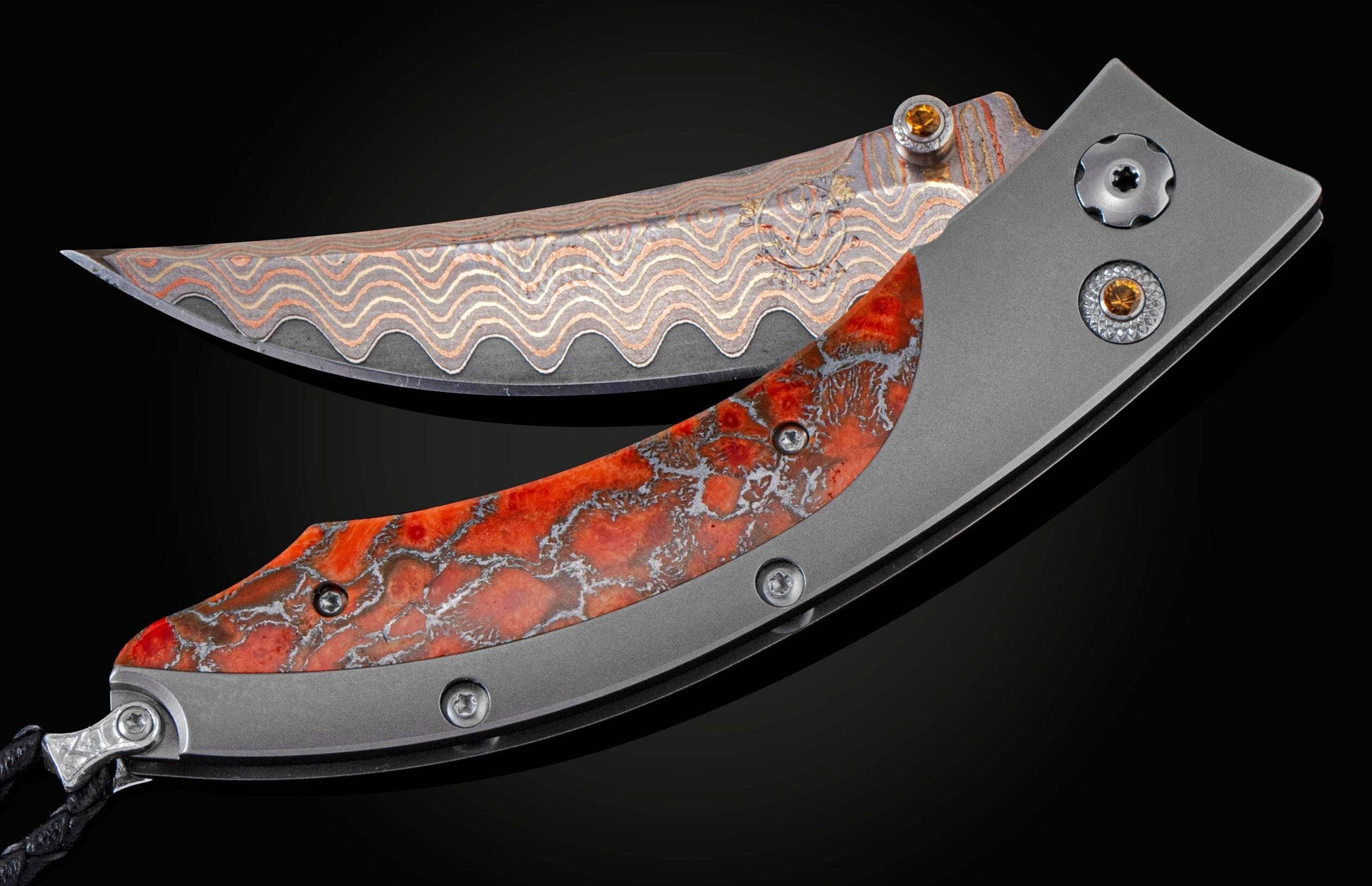 Handcrafted pocket knife from William Henry features a titanium frame inlaid with orange and red zinc matrix Apple Coral. The button lock and the thumb stud have been set with citrine gemstones and the hand forged Damascus steel blade has a copper wave pa