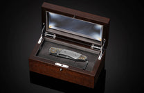 Handcrafted William Henry knife features a hand-carved sterling silver frame with watch gears by Lee Downey