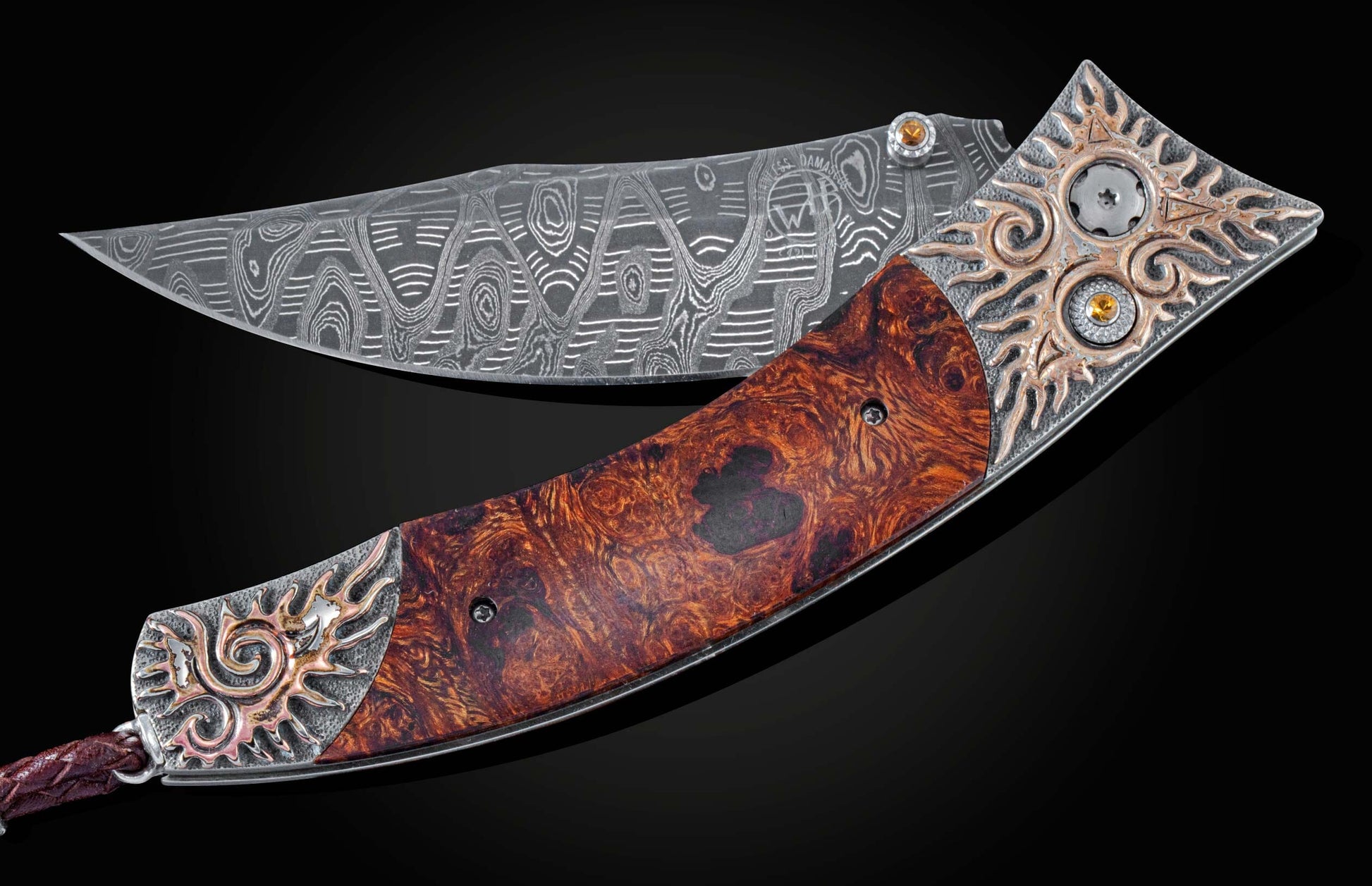Handcrafted pocketknife from William Henry features a beautiful frame in hand-carved sterling silver with mokume gane, inlaid with desert ironwood and  citrine gemstones. The blade is hand-forged Damascus steel.