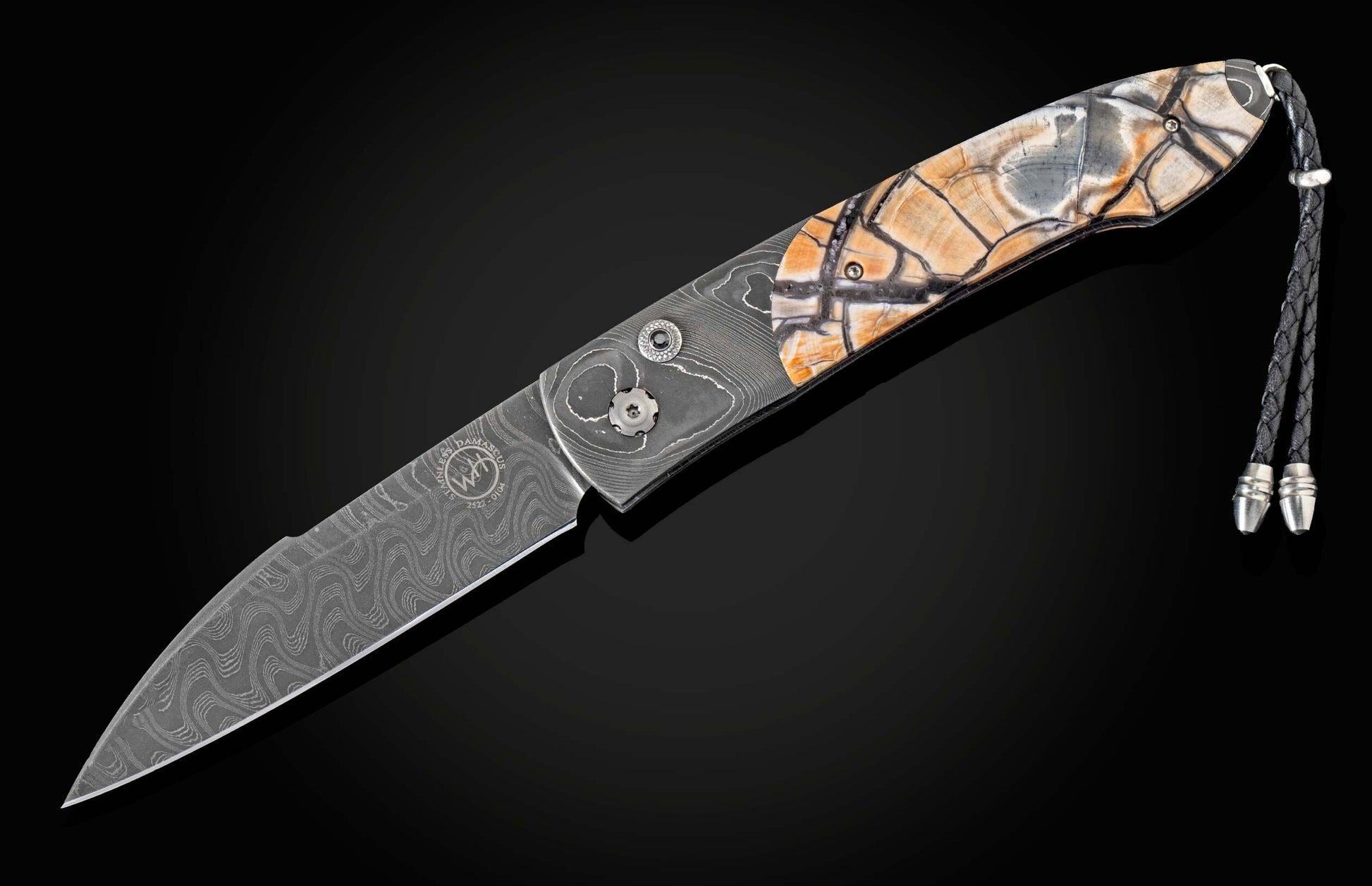 Handcrafted William Henry custom automatic knife features a hand-forged Damascus steel frame by Chad Nichols, inlaid with fossil Woolly Mammoth tusk, spinel gemstones and a hand-forged Damascus steel blade, also by Chad Nichols.