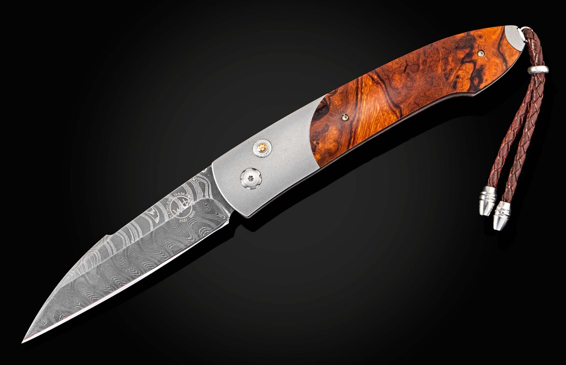 Handcrafted William Henry custom automatic knife features a titanium frame, inlaid with Desert Ironwood scales, citrine gemstones, and a hand-forged Damascus steel blade by Chad Nichols