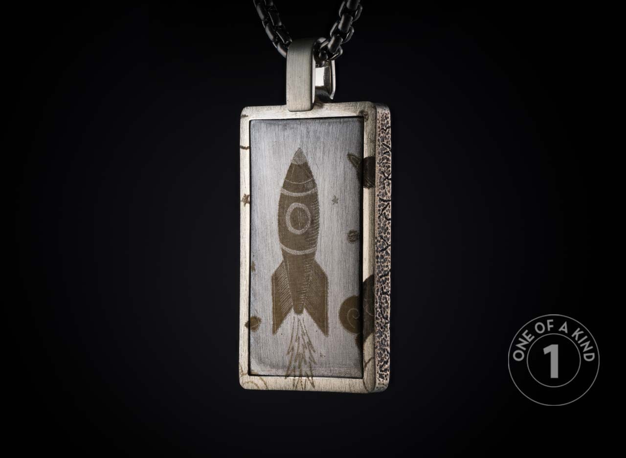One of a kind sterling silver pendant necklace from William Henry featuring a laser engraved meteorite inlay.