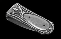Handcrafted luxury money clip from William Henry featuring hand-carved sterling silver inlaid with Gibeon meteorite scales.