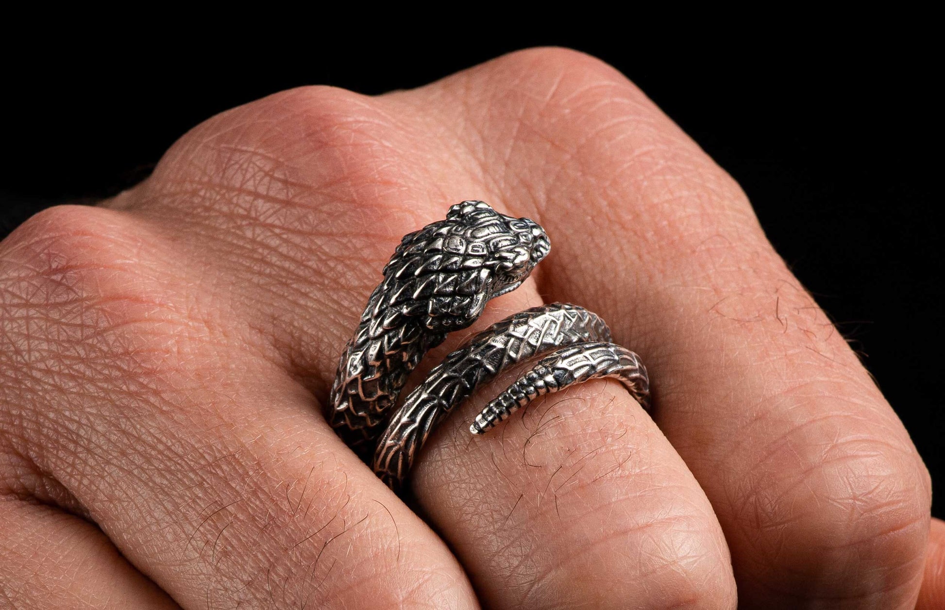 A Sculpted Sterling Silver Snake Ring on a finger