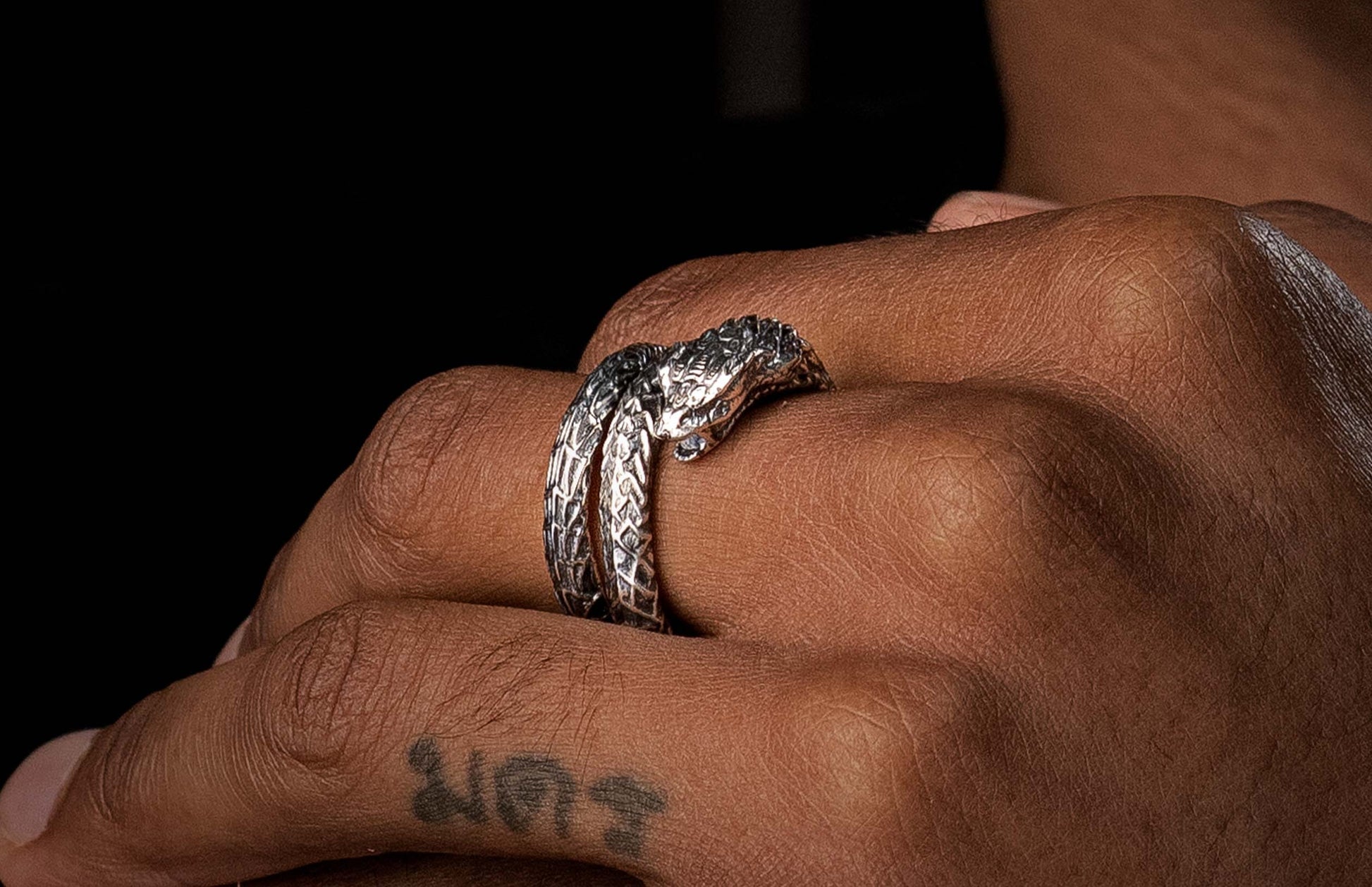 A Sculpted Sterling Silver Snake Ring on a finger