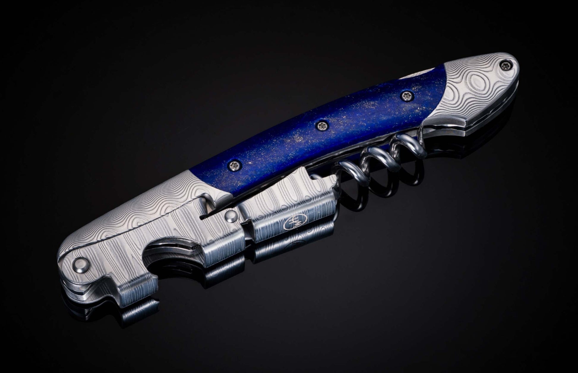 Custom William Henry wine opener is a double hinged sommelier’s corkscrew featuring a Damascus steel frame, lever, and foil cutter with Lapis Lazuli inlay.