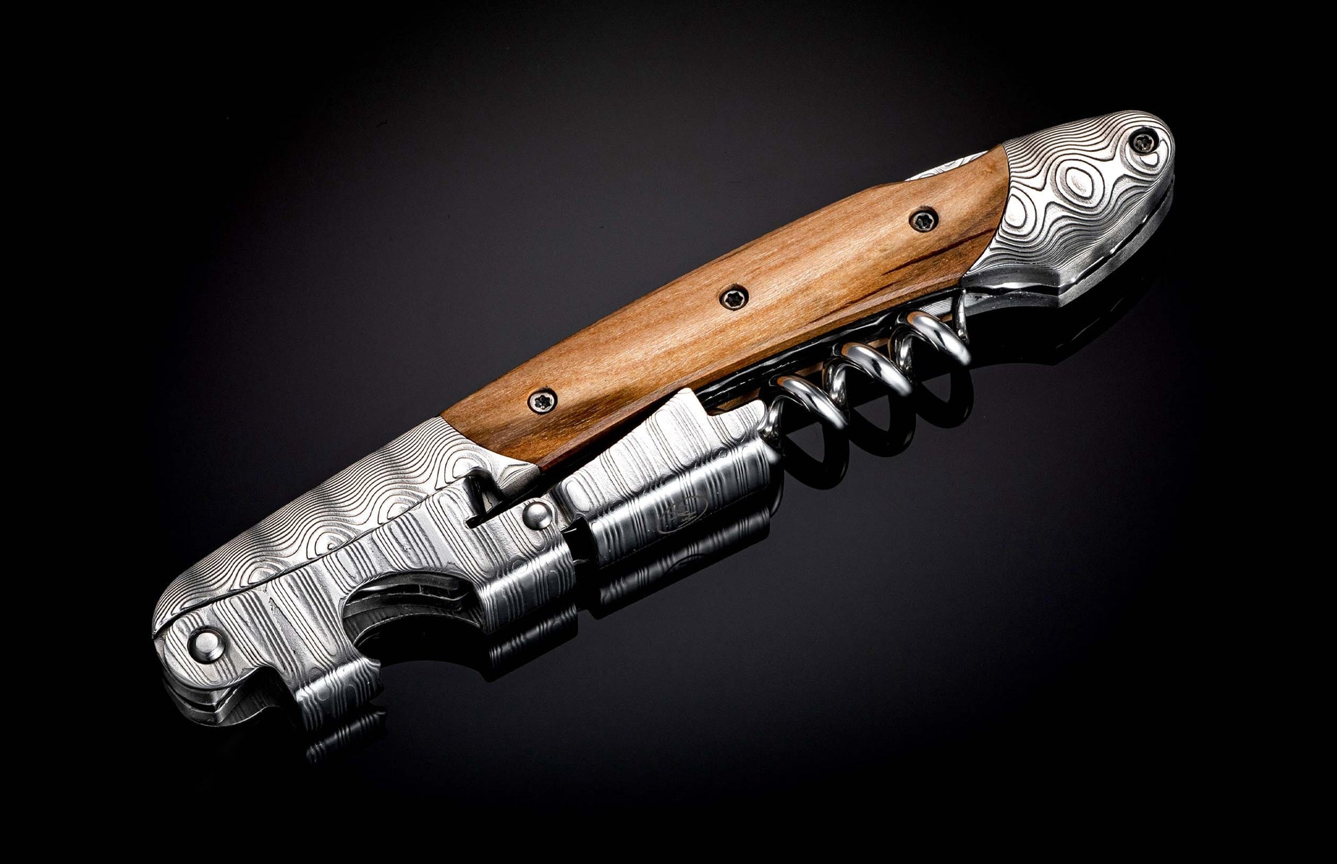 Handcrafted William Henry Corkscrew is a double hinged sommelier’s tool featuring a Damascus steel frame, lever, and foil cutter featuring inlays cut from the vines of the original Eyrie Vinyard Pinot Noir